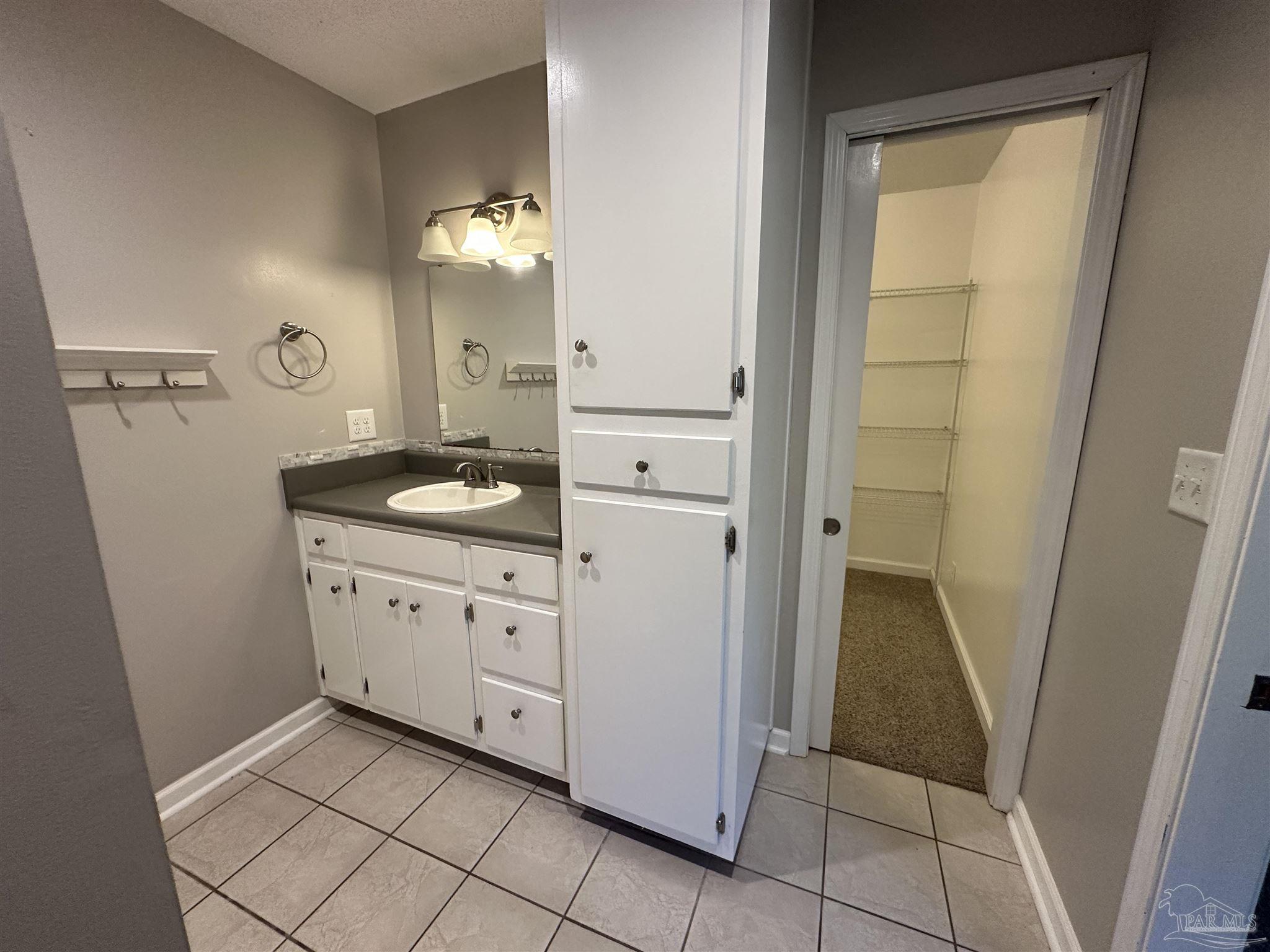 7720 Jansen Road Pensacola, FL 32526 - Photo 16 of 30 a spacious bathroom with a granite countertop sink and a mirror