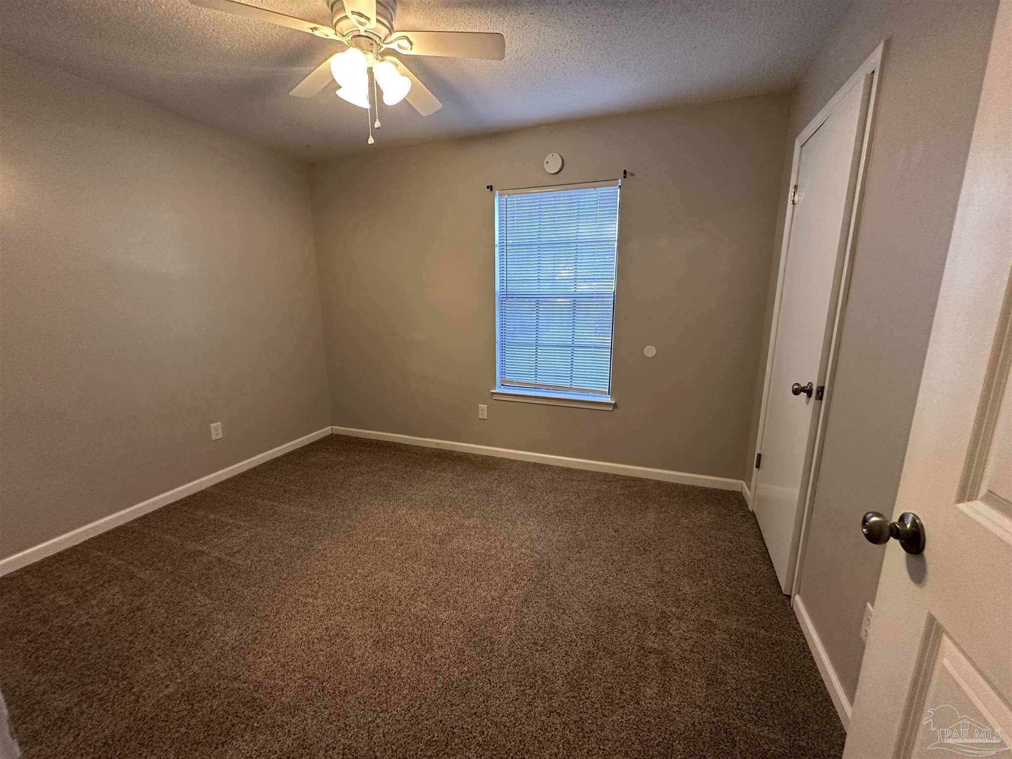 7720 Jansen Road Pensacola, FL 32526 - Photo 28 of 30 an empty room with windows and fan