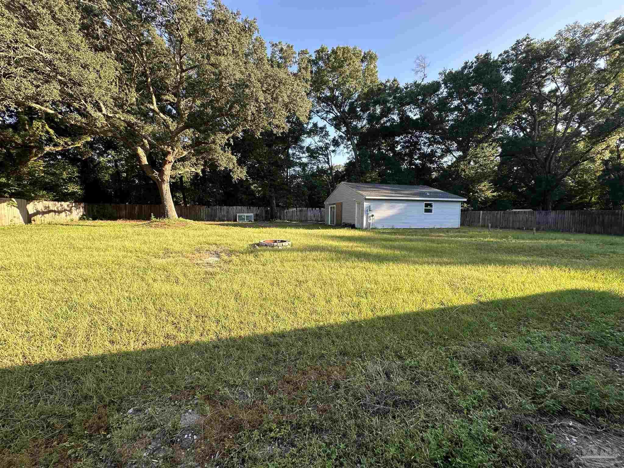 7720 Jansen Road Pensacola, FL 32526 - Photo 3 of 30 a view of a swimming pool with an outdoor space and seating area