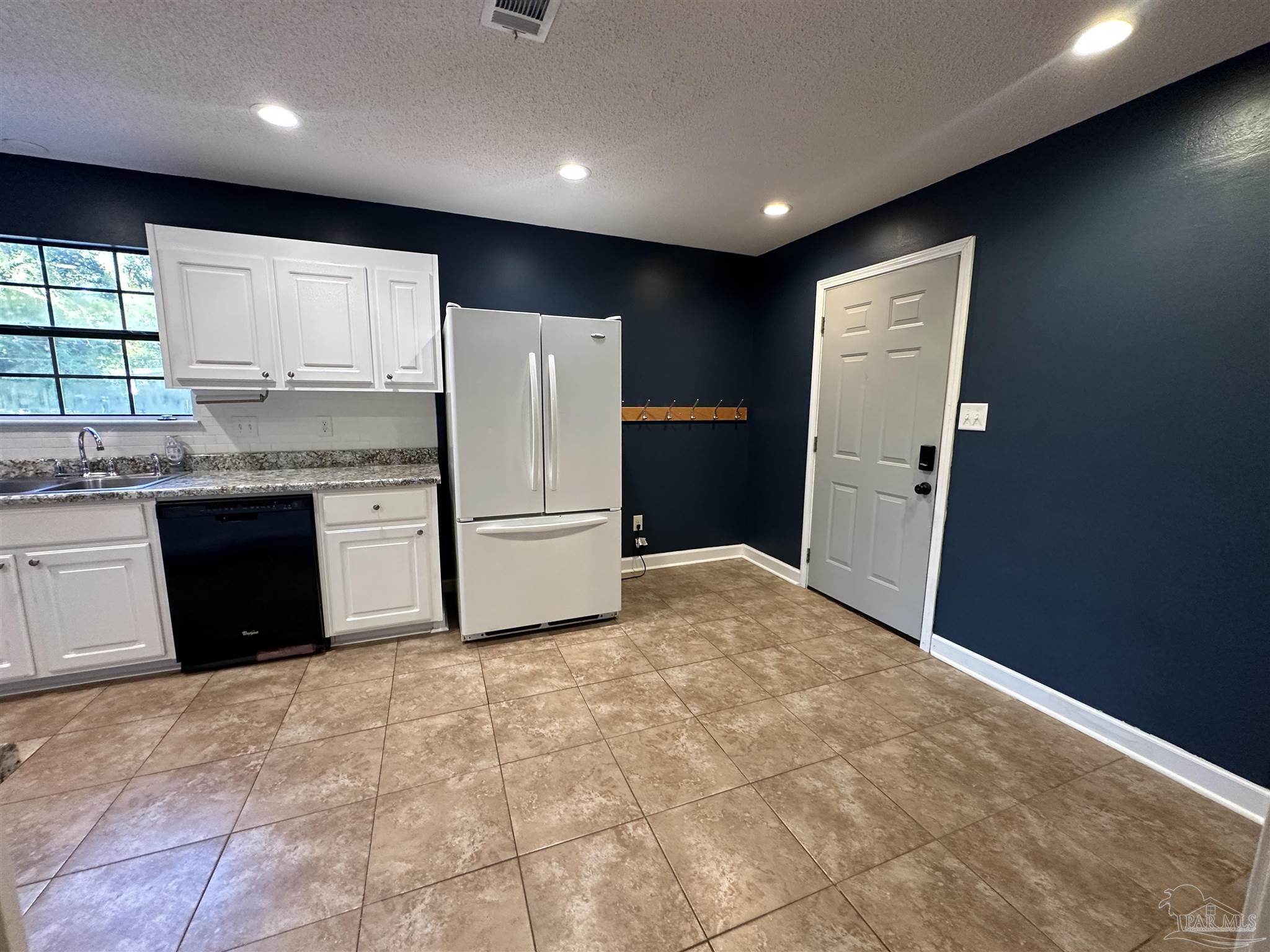 7720 Jansen Road Pensacola, FL 32526 - Photo 6 of 30 a kitchen with refrigerator cabinets and a sink