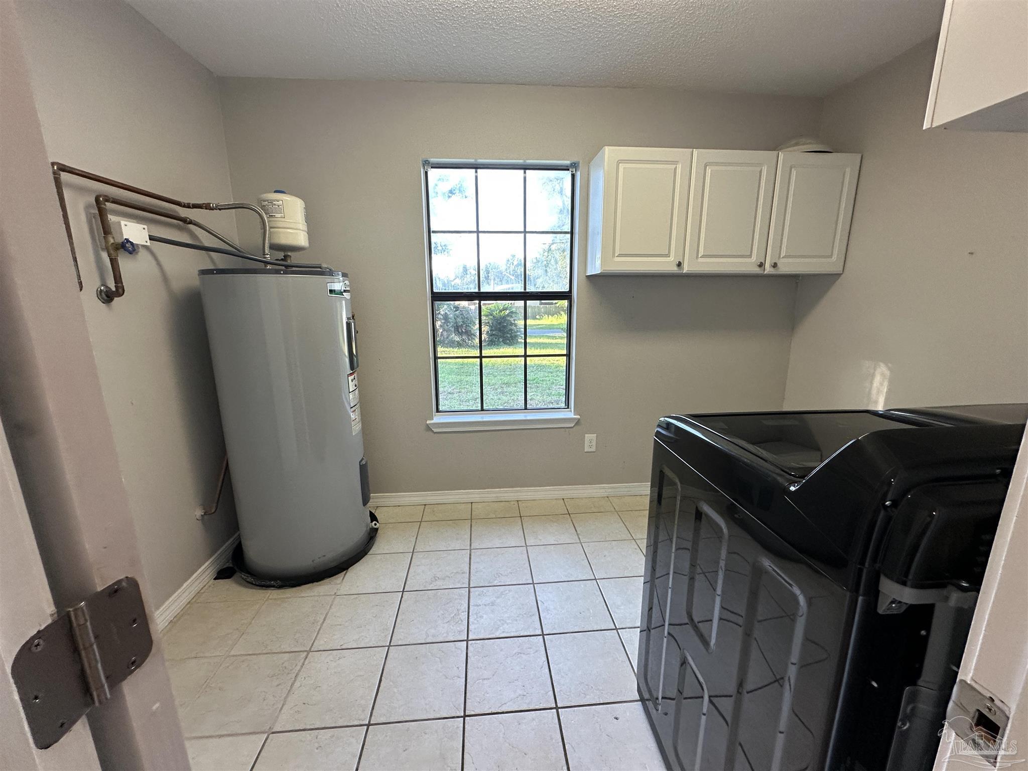 7720 Jansen Road Pensacola, FL 32526 - Photo 9 of 30 a kitchen with a refrigerator and window