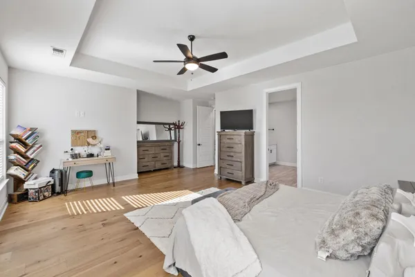 a bedroom with furniture and a flat screen tv