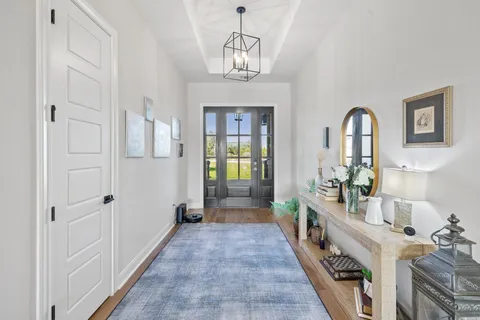 a view of a hallway with a chandelier