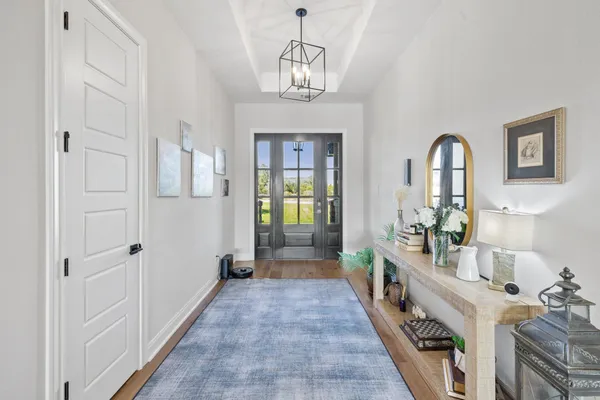 a view of a hallway with a chandelier