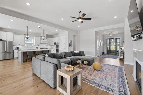 a living room with furniture and kitchen view
