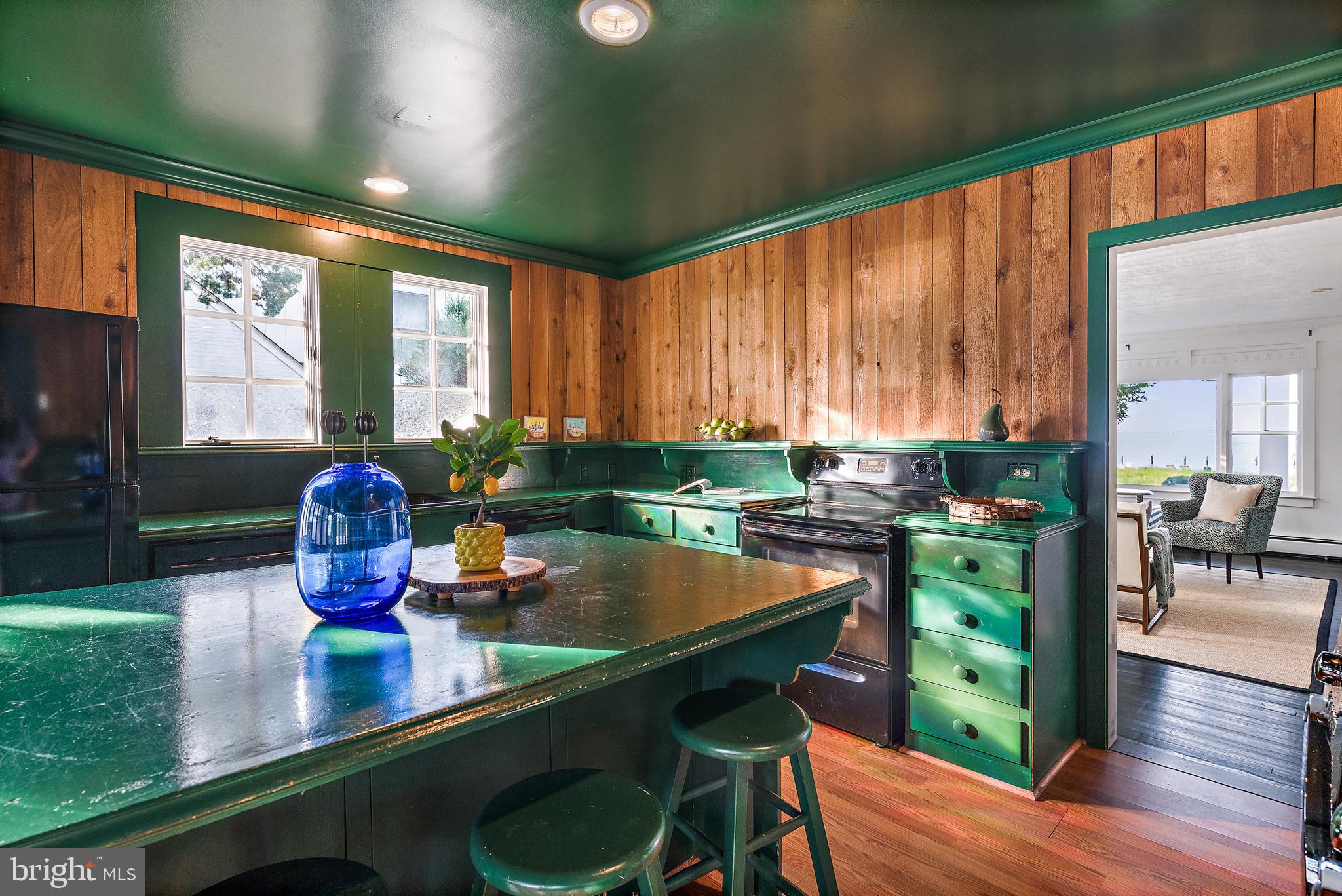 90 River Drive Annapolis, MD 21403 - Photo 18 of 44 a kitchen with stainless steel appliances wooden cabinets dining table and chairs