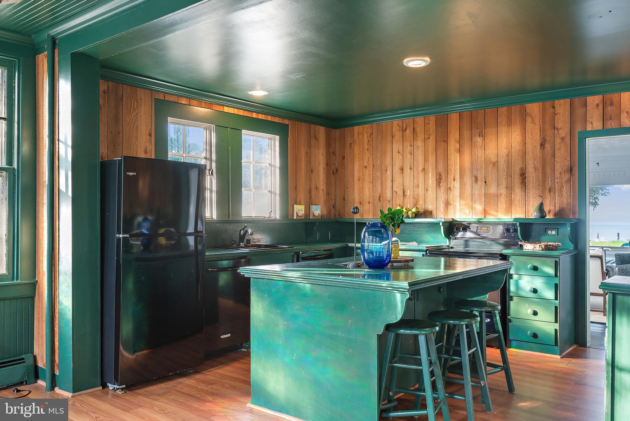90 River Drive Annapolis, MD 21403 - Photo 19 of 44 a kitchen with a table chairs refrigerator and cabinets