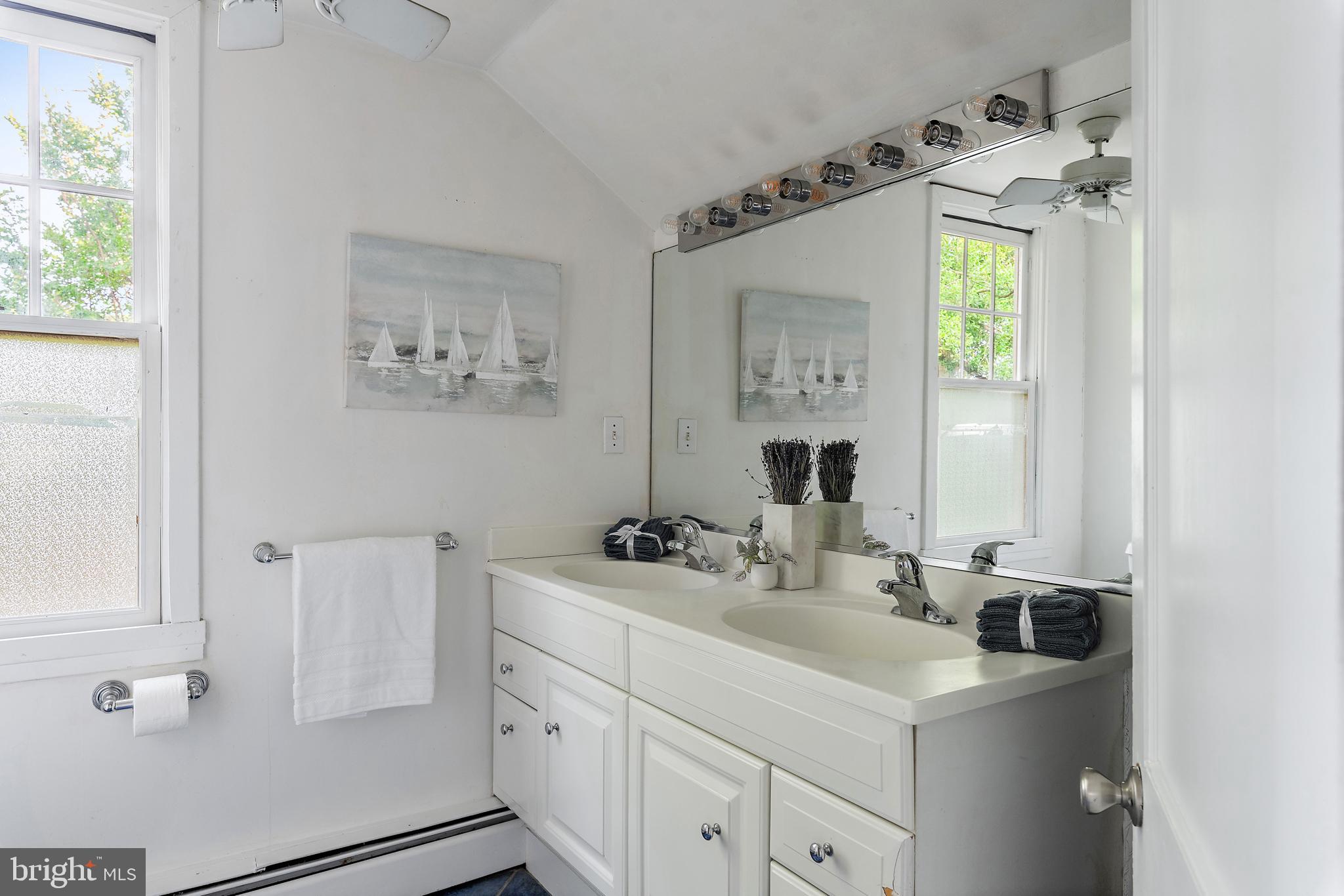 90 River Drive Annapolis, MD 21403 - Photo 27 of 44 a bathroom with a sink and a mirror