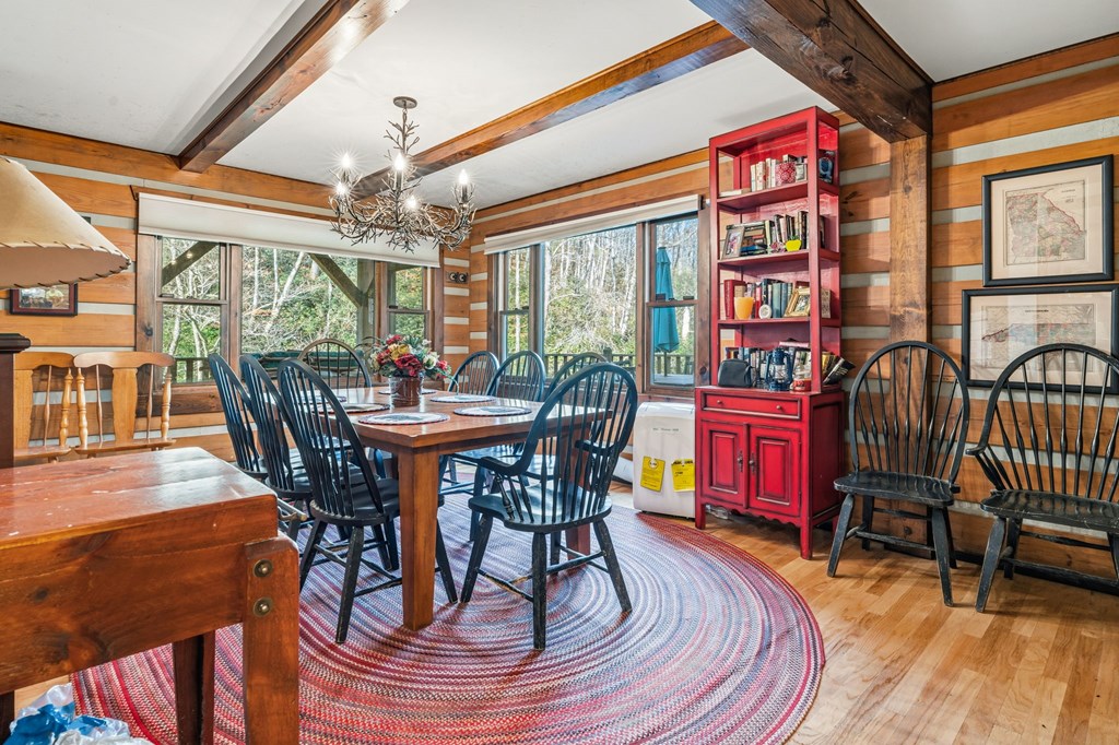 4662 Rainbow Springs Road Franklin, NC 28734 - Photo 13 of 39 a dining room with furniture a floor to ceiling window and wooden floor