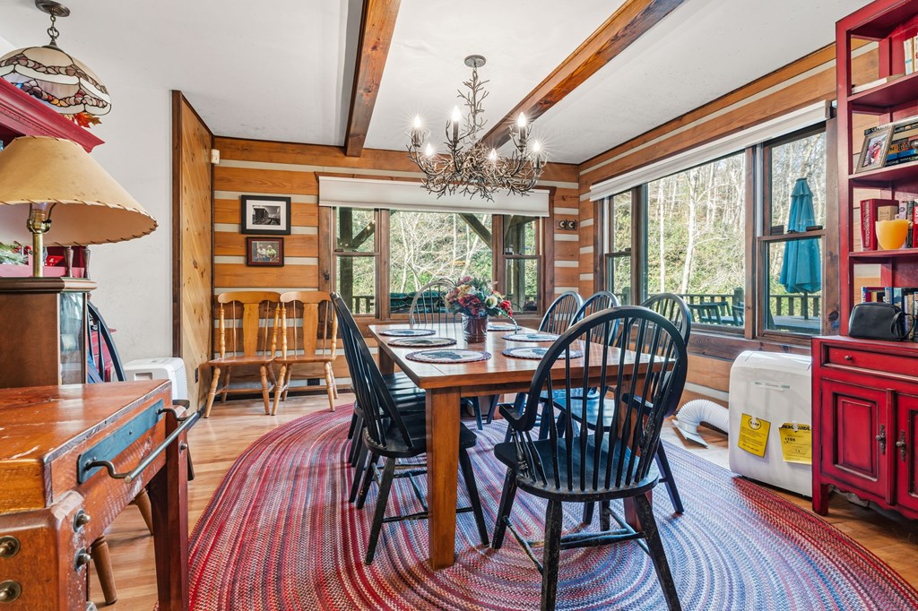 4662 Rainbow Springs Road Franklin, NC 28734 - Photo 14 of 39 a view of a dining room with furniture a chandelier and wooden floor