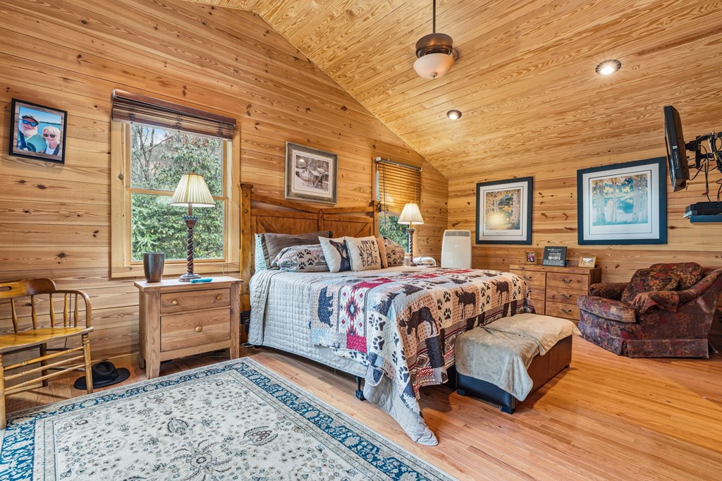 4662 Rainbow Springs Road Franklin, NC 28734 - Photo 17 of 39 a bedroom with a bed and wooden floor