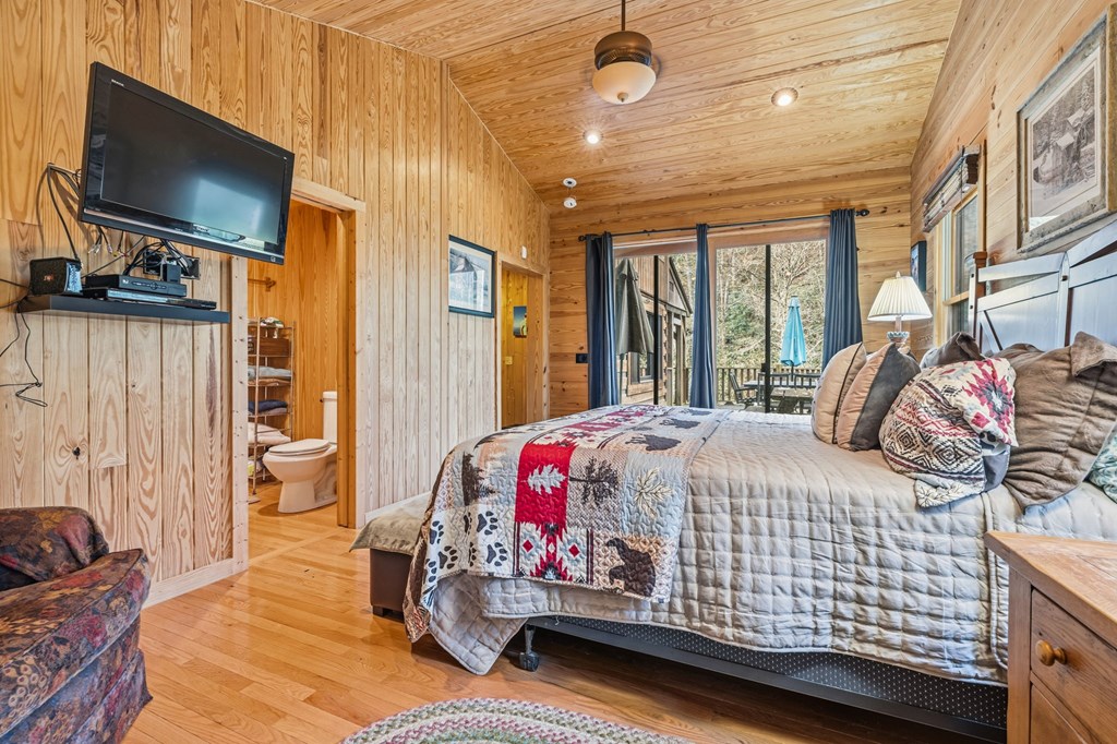 4662 Rainbow Springs Road Franklin, NC 28734 - Photo 18 of 39 a bedroom with a bed and flat screen tv