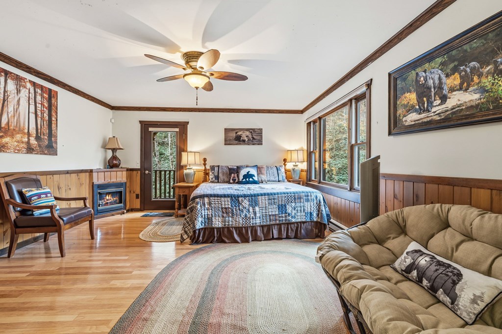 4662 Rainbow Springs Road Franklin, NC 28734 - Photo 27 of 39 a bedroom with a bed and wooden floor
