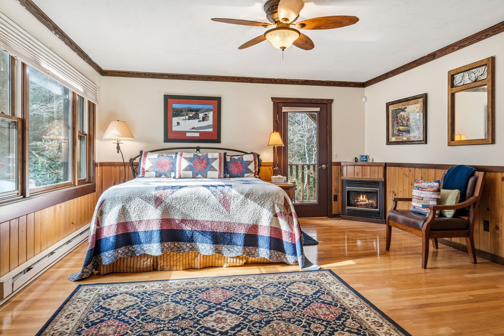 4662 Rainbow Springs Road Franklin, NC 28734 - Photo 33 of 39 a bedroom with a bed and wooden floor