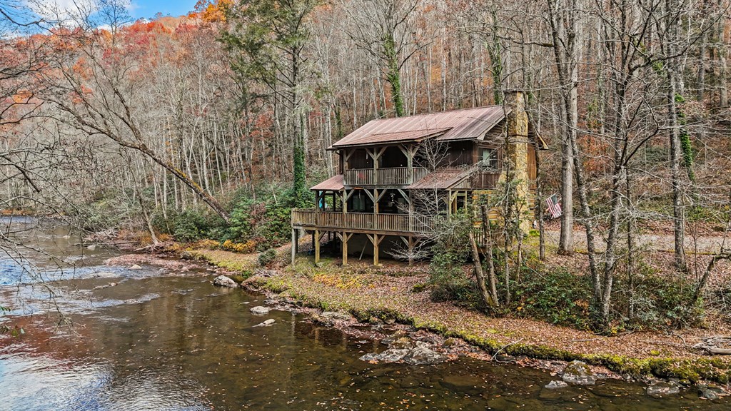 4662 Rainbow Springs Road Franklin, NC 28734 - Photo 6 of 39 a view of a wooden deck with chairs and a yard