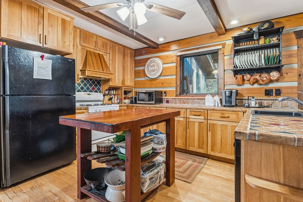 4662 Rainbow Springs Road Franklin, NC 28734 - Photo 8 of 39 a kitchen with stainless steel appliances granite countertop a stove and a refrigerator