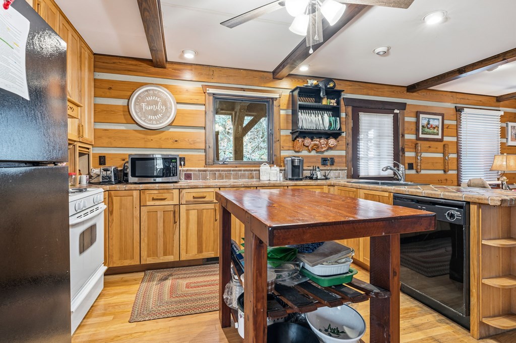 4662 Rainbow Springs Road Franklin, NC 28734 - Photo 9 of 39 a kitchen with stainless steel appliances granite countertop a stove and a wooden cabinets