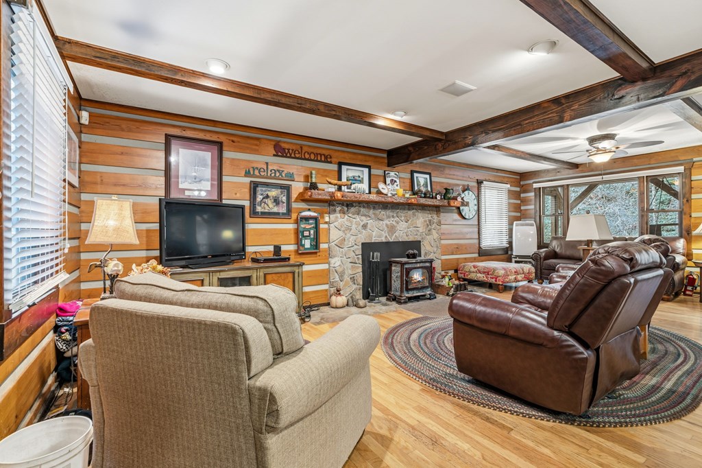 4662 Rainbow Springs Road Franklin, NC 28734 - Photo 10 of 39 a living room with furniture a flat screen tv and a fireplace