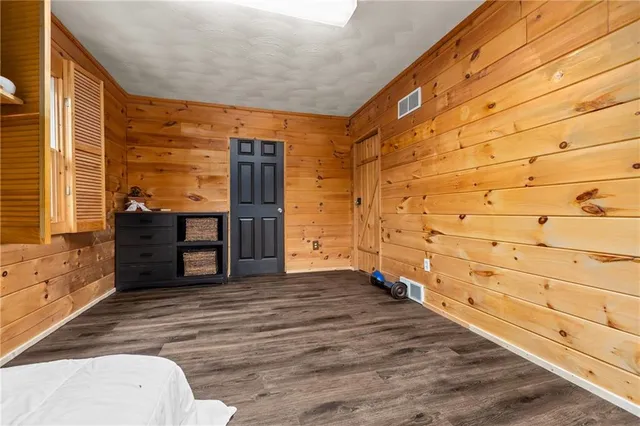 a bedroom with a bed and a dresser