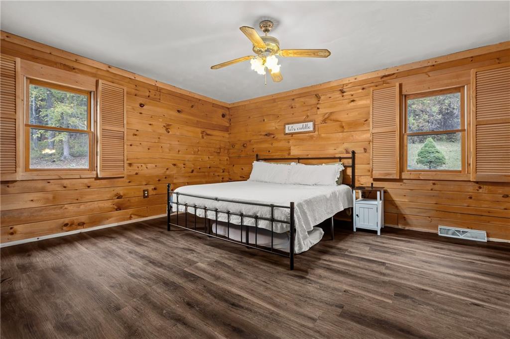 566 Pettit Road Waynesburg, PA 15370 - Photo 32 of 50 a bedroom with a bed and a large window with wooden floor