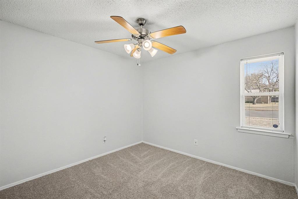125 Roundtree Street Crowley, TX 76036 - Photo 12 of 25 an empty room with window and ceiling fan