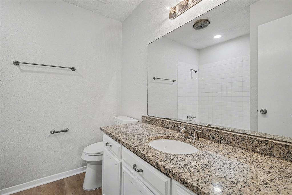 125 Roundtree Street Crowley, TX 76036 - Photo 15 of 25 a bathroom with a granite countertop sink and a mirror
