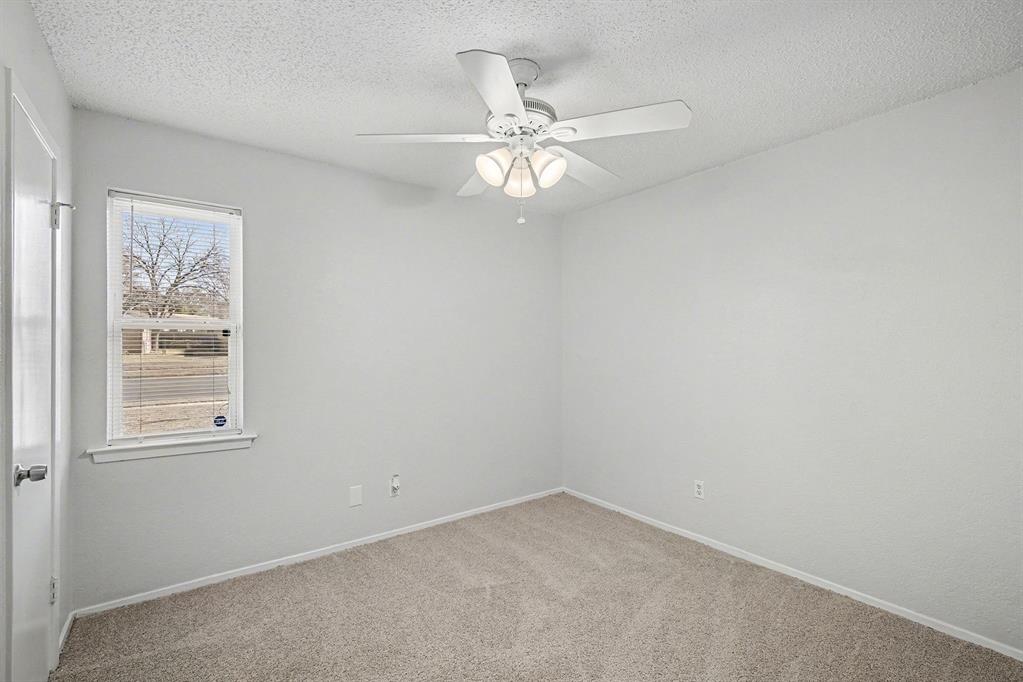 125 Roundtree Street Crowley, TX 76036 - Photo 16 of 25 an empty room with a window and a fan