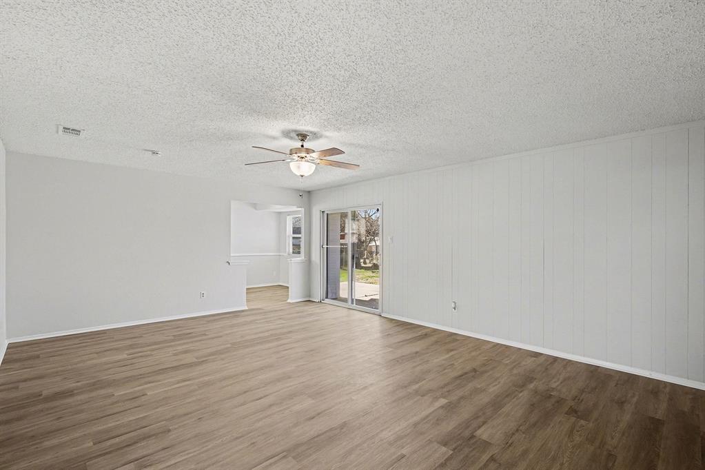 125 Roundtree Street Crowley, TX 76036 - Photo 7 of 25 a view of an empty room with wooden floor