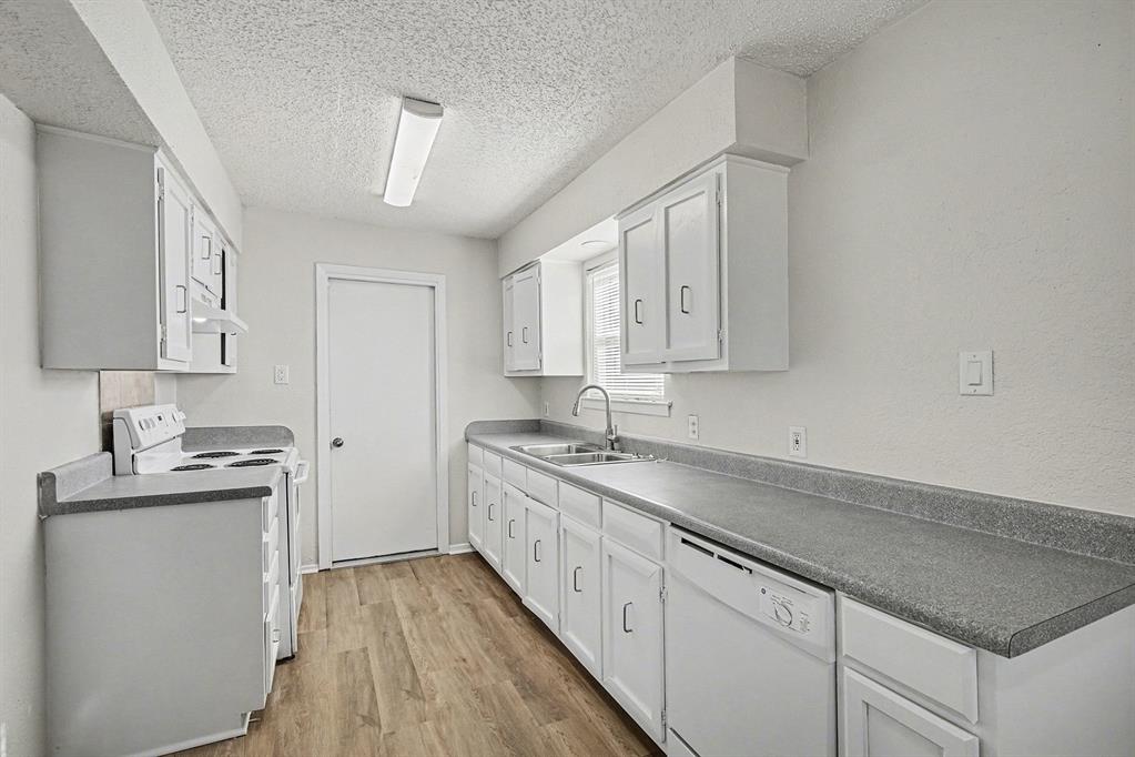 125 Roundtree Street Crowley, TX 76036 - Photo 9 of 25 a kitchen with stainless steel appliances granite countertop a sink stove and cabinets