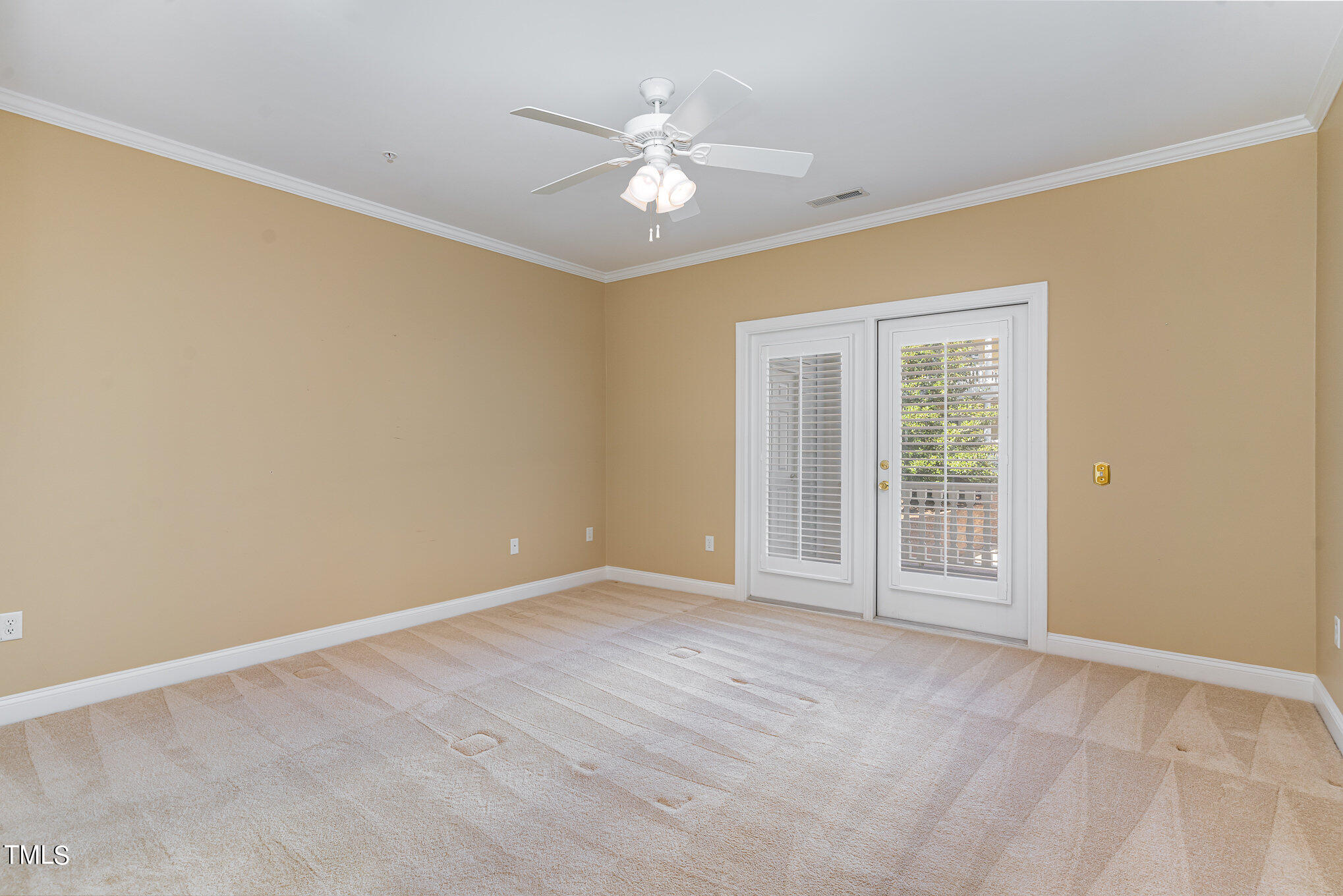 7510 Lead Mine Road, Unit 104 Raleigh, NC 27615 - Photo 12 of 23 Primary bedroom with French doors leading out to the covered brick patio/balcony