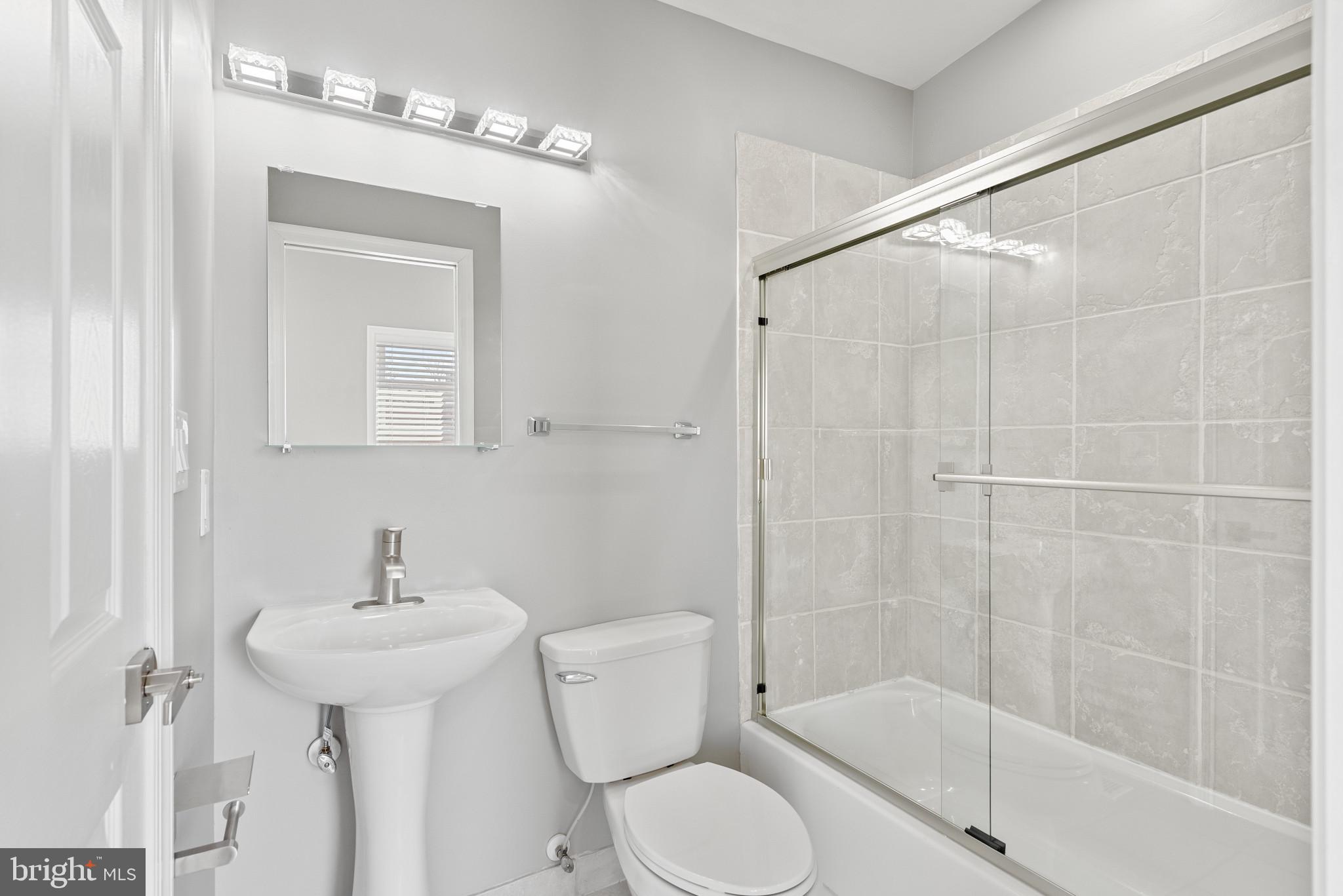 1410 Ramsay Street Baltimore, MD 21223 - Photo 9 of 23 Front Bedroom with Clean and Modern Full Bathroom