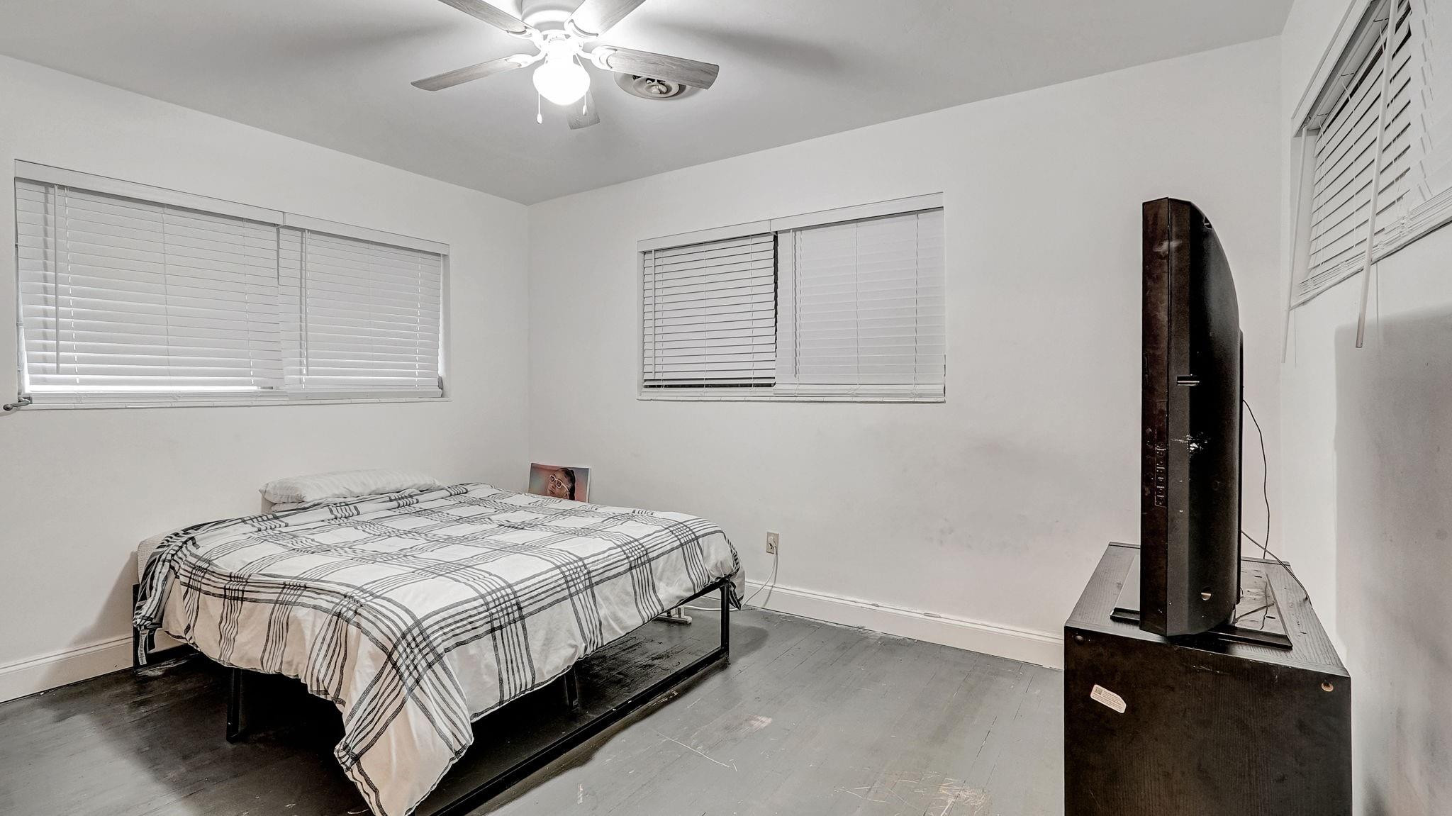 3410 Cleveland Street Hollywood, FL 33021 - Photo 15 of 63 a bedroom with a bed and a chandelier