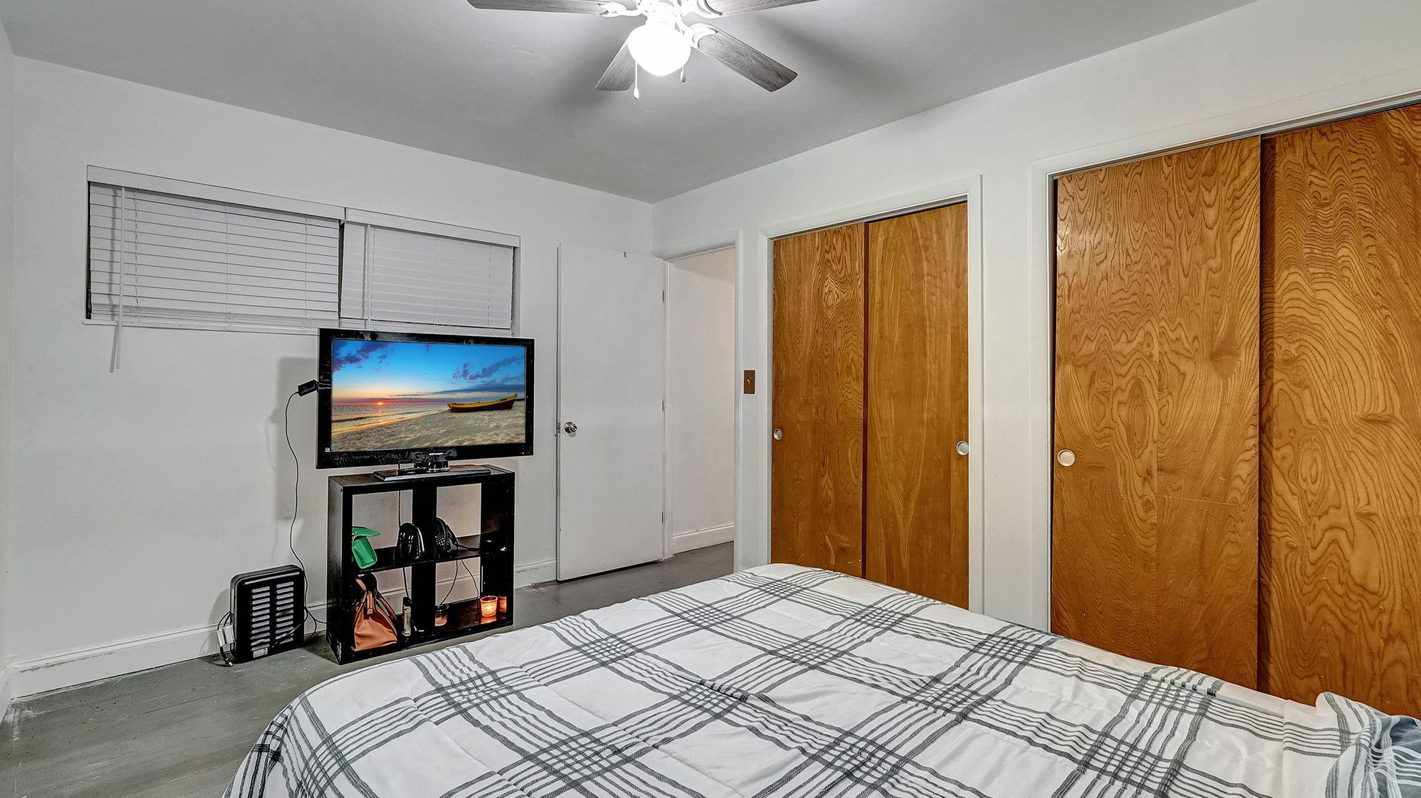 3410 Cleveland Street Hollywood, FL 33021 - Photo 16 of 63 a bedroom with bed and a flat tv screen