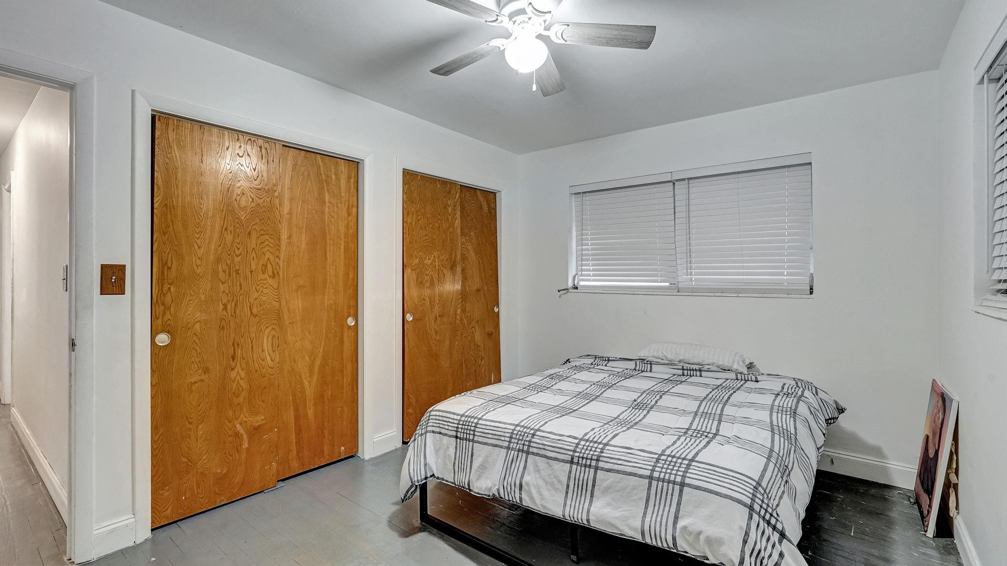 3410 Cleveland Street Hollywood, FL 33021 - Photo 17 of 63 a bedroom with a bed and a chandelier