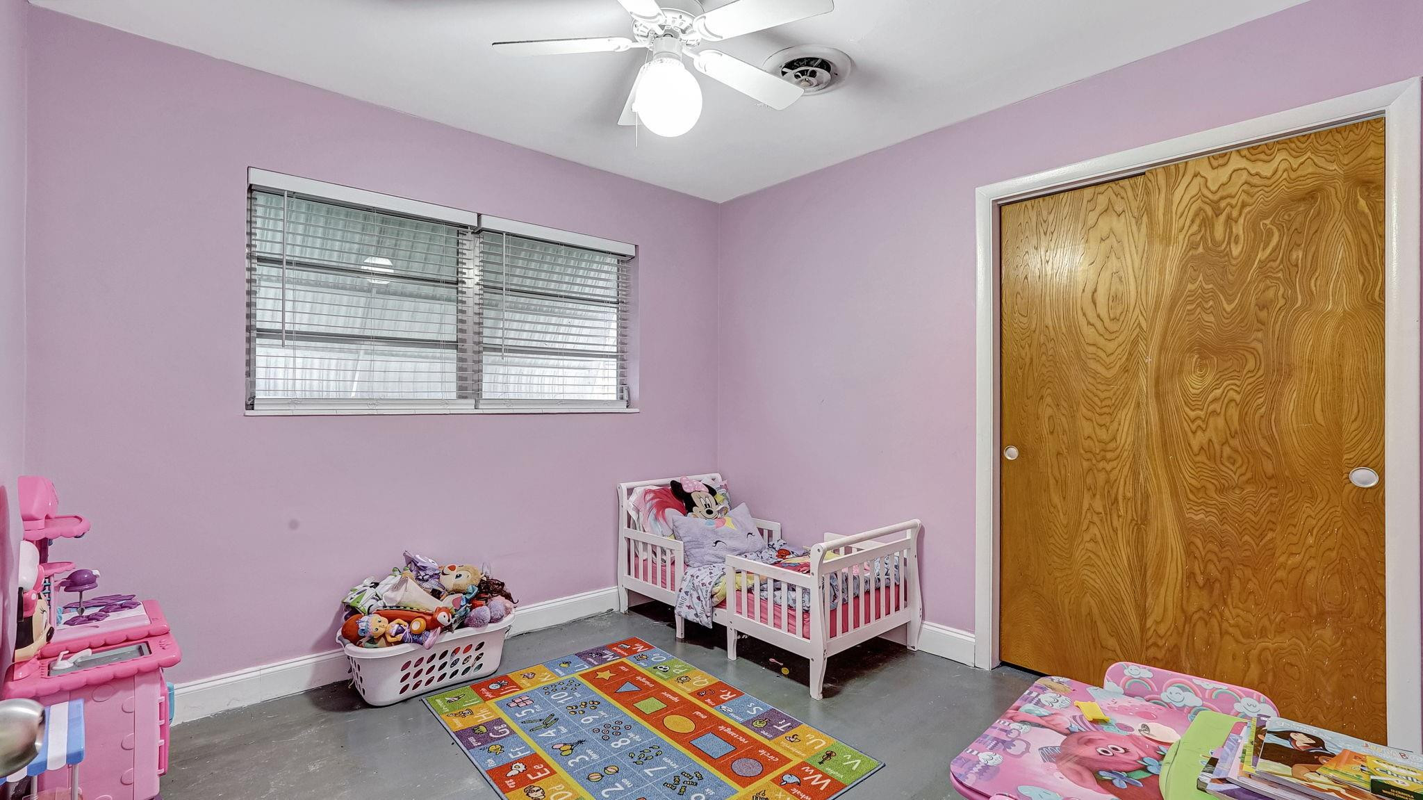 3410 Cleveland Street Hollywood, FL 33021 - Photo 19 of 63 a bedroom with a bed and a window