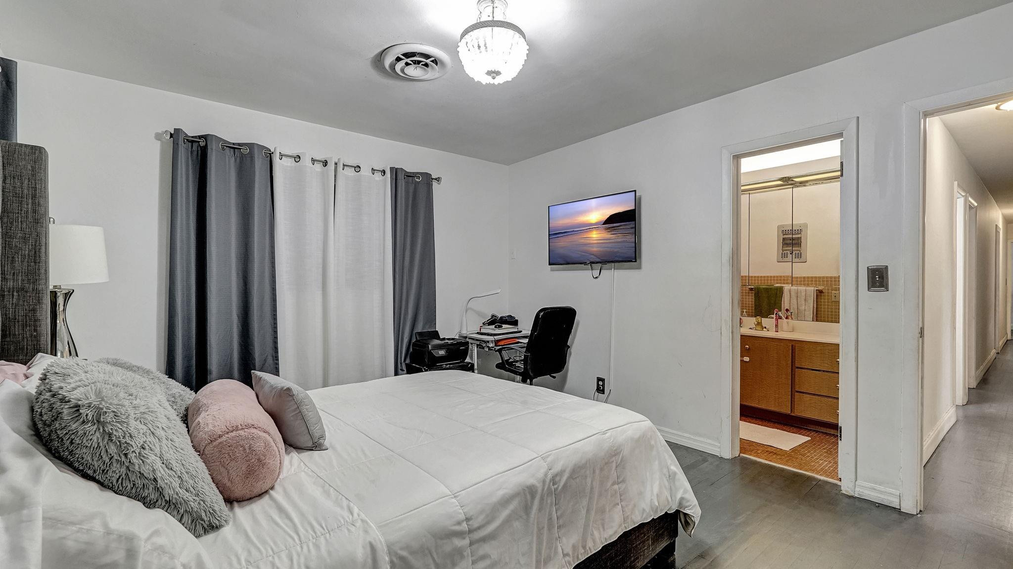 3410 Cleveland Street Hollywood, FL 33021 - Photo 24 of 63 a bedroom with a bed and a flat screen tv