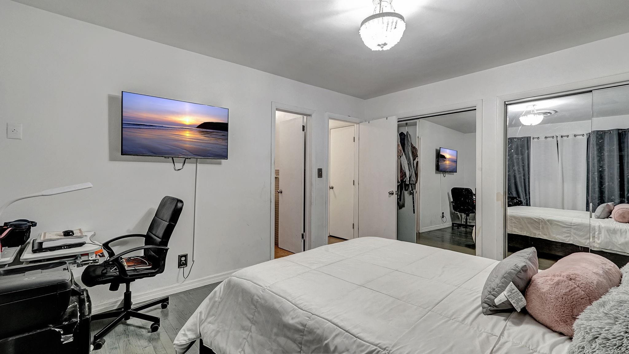 3410 Cleveland Street Hollywood, FL 33021 - Photo 25 of 63 a bedroom with a bed and a flat screen tv