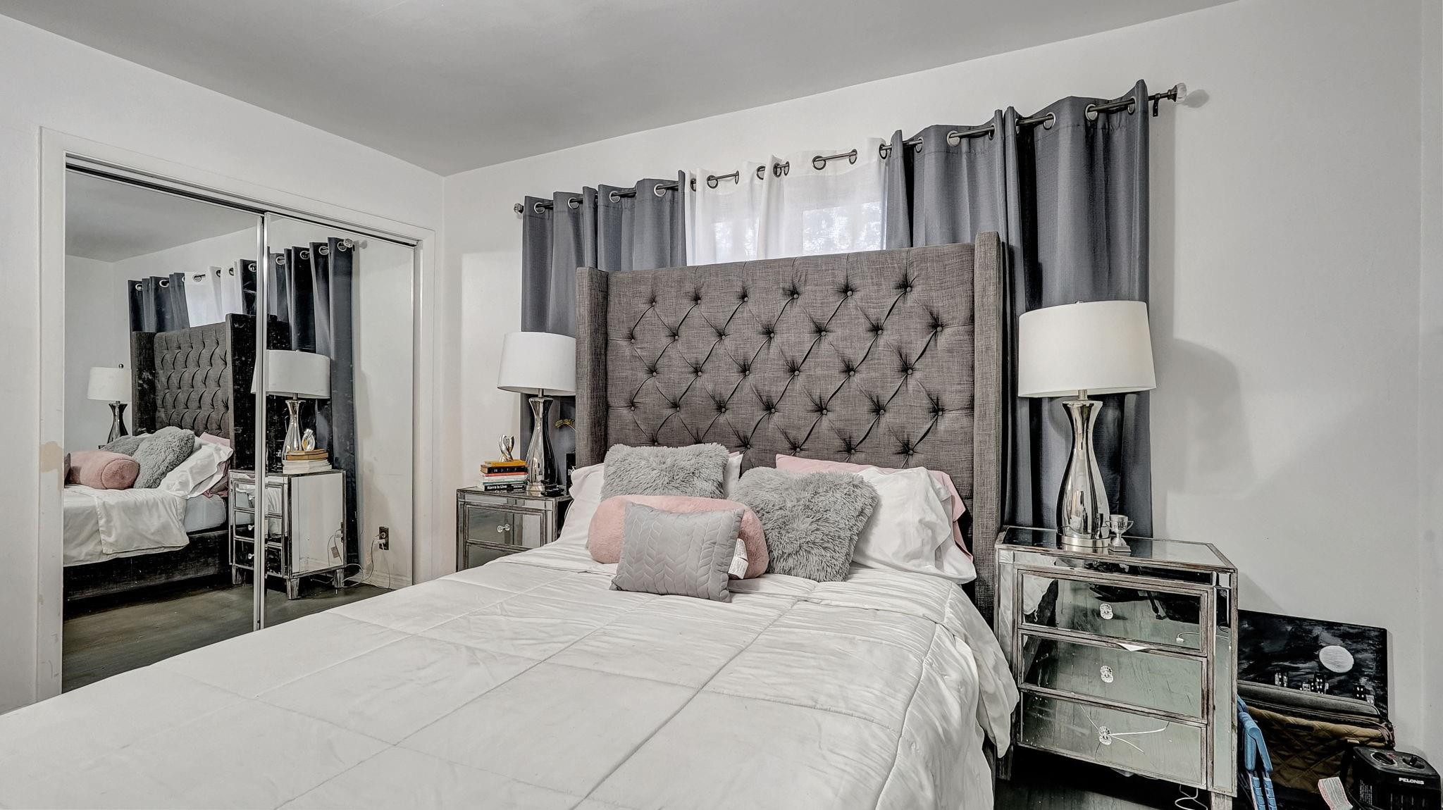 3410 Cleveland Street Hollywood, FL 33021 - Photo 26 of 63 a bedroom with a bed and a mirror