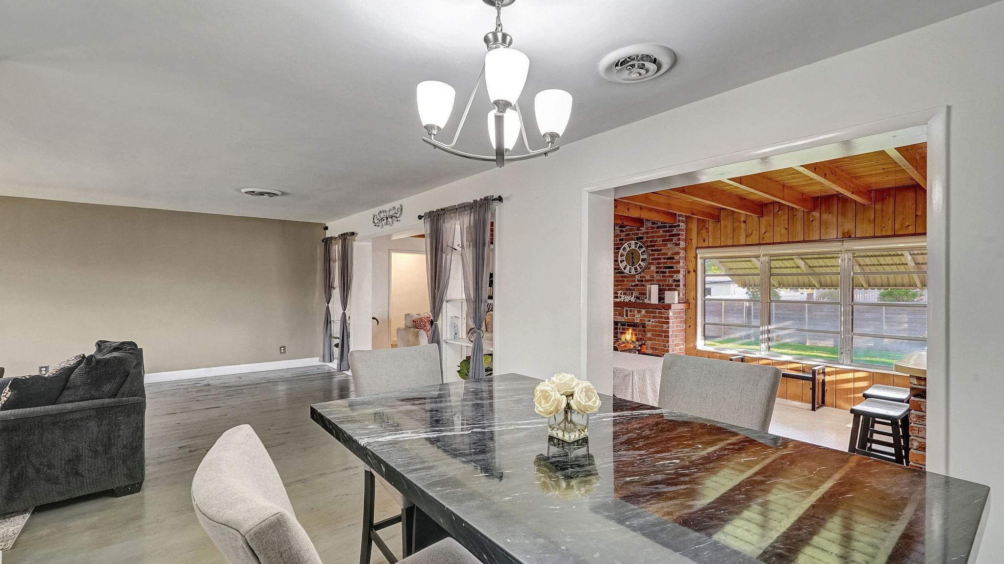 3410 Cleveland Street Hollywood, FL 33021 - Photo 37 of 63 a view of a dining room with furniture wooden floor and chandelier