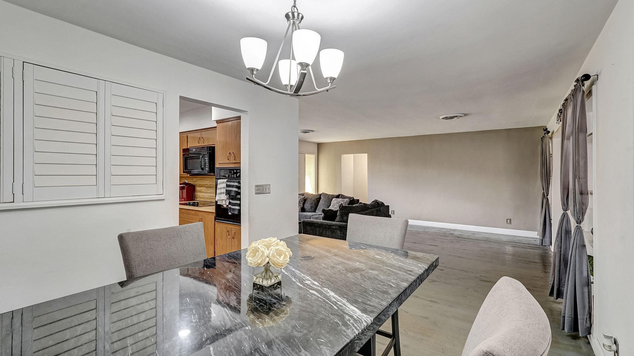 3410 Cleveland Street Hollywood, FL 33021 - Photo 38 of 63 a view of a dining room with furniture a chandelier and wooden floor