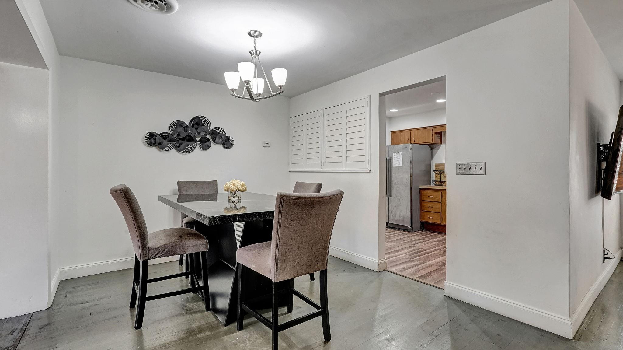 3410 Cleveland Street Hollywood, FL 33021 - Photo 45 of 63 a view of a dining room with furniture and chandelier