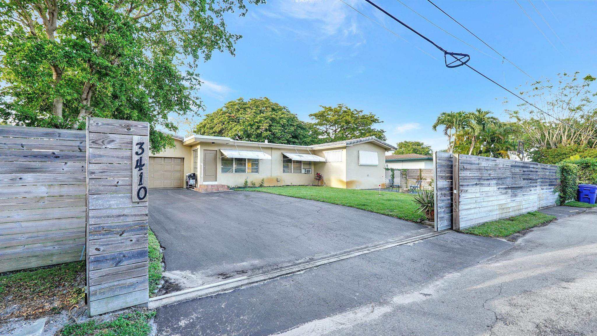 3410 Cleveland Street Hollywood, FL 33021 - Photo 57 of 63 a view of a house with a yard and potted plants