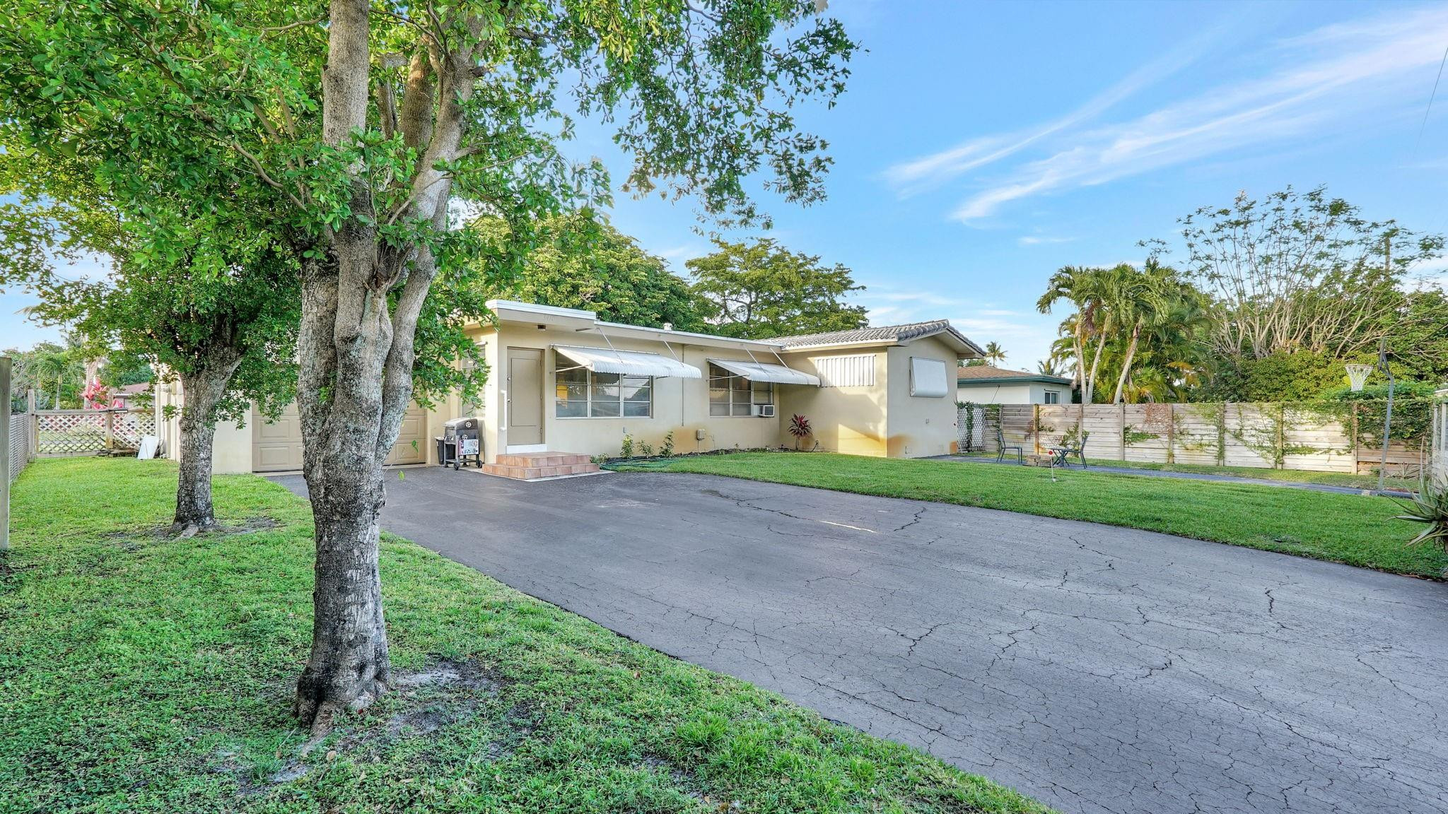 3410 Cleveland Street Hollywood, FL 33021 - Photo 58 of 63 a view of a house with a yard and large trees