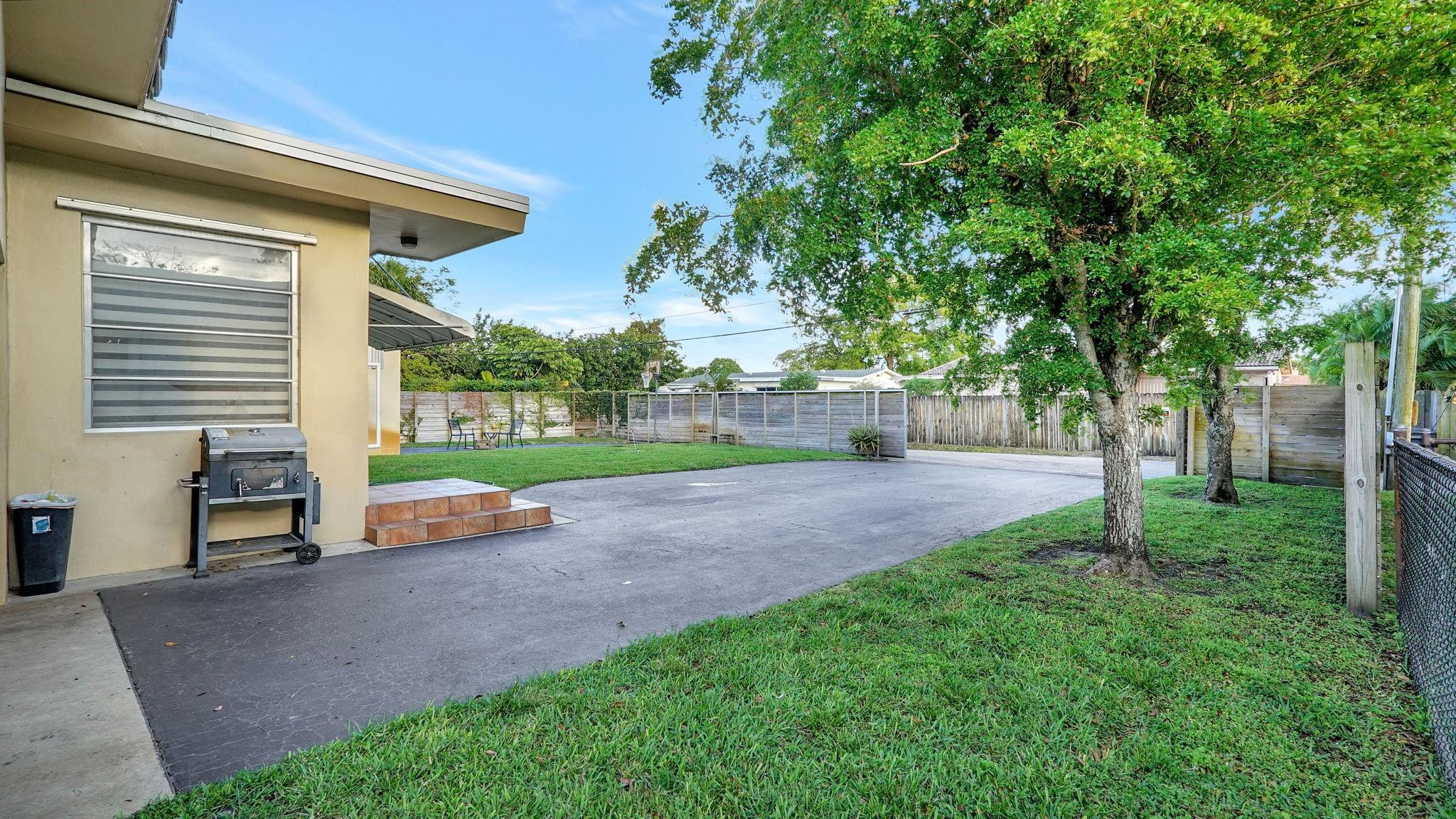 3410 Cleveland Street Hollywood, FL 33021 - Photo 59 of 63 a view of a house with backyard and a tree