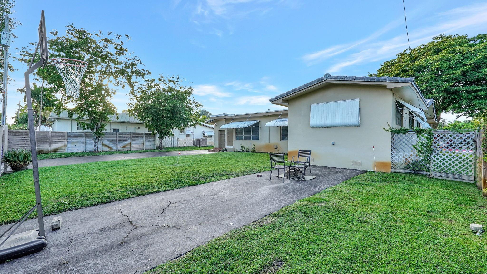 3410 Cleveland Street Hollywood, FL 33021 - Photo 60 of 63 a front view of house with yard and green space