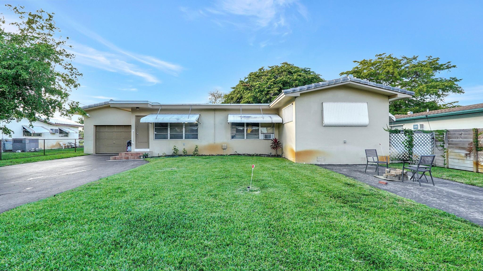 3410 Cleveland Street Hollywood, FL 33021 - Photo 62 of 63 a view of a house with a yard and a garden