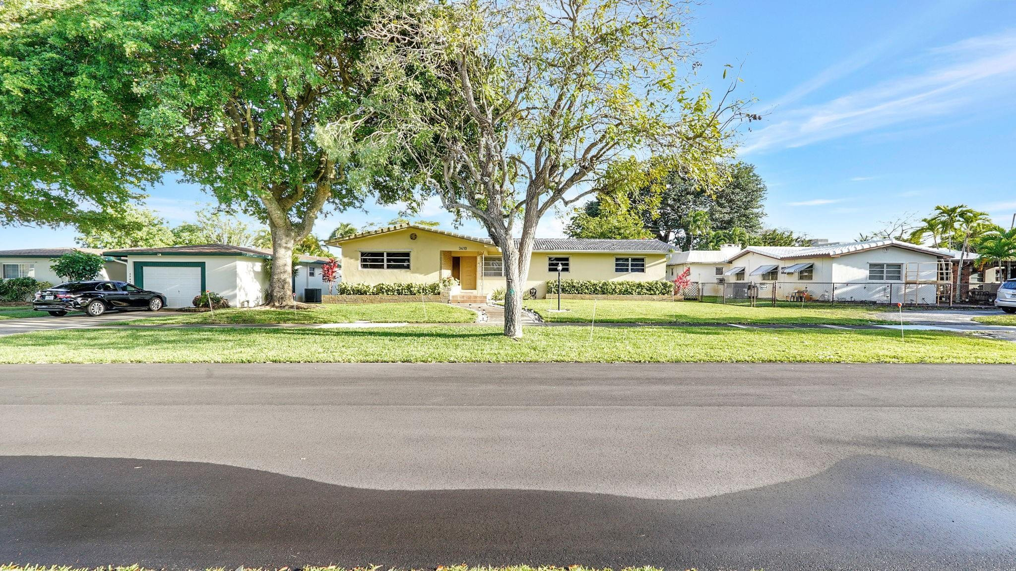 3410 Cleveland Street Hollywood, FL 33021 - Photo 63 of 63 a view of a house with a big yard and large trees