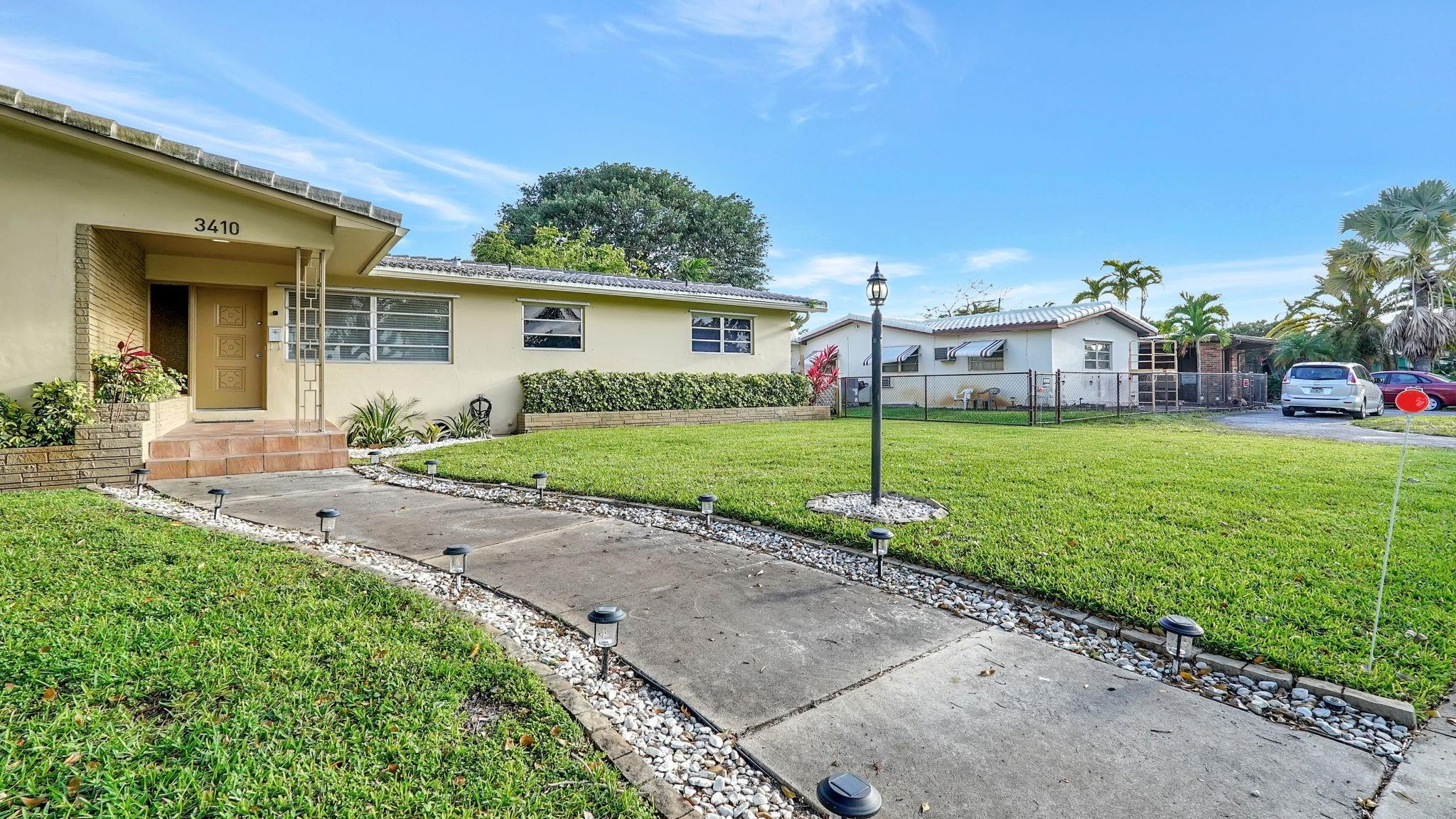 3410 Cleveland Street Hollywood, FL 33021 - Photo 8 of 63 front view of a house with a yard