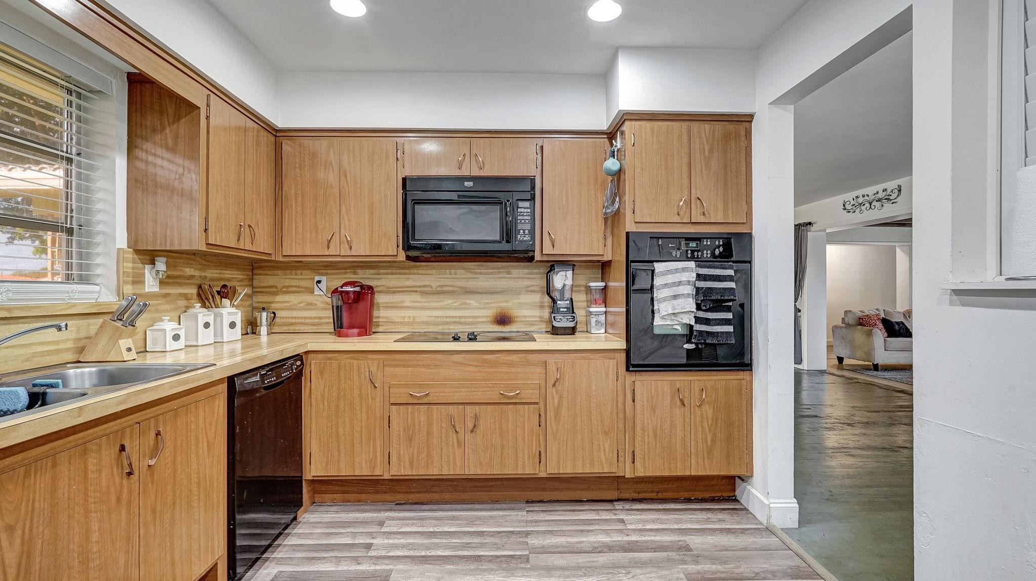 3410 Cleveland Street Hollywood, FL 33021 - Photo 10 of 63 a kitchen with stainless steel appliances a stove sink microwave and cabinets