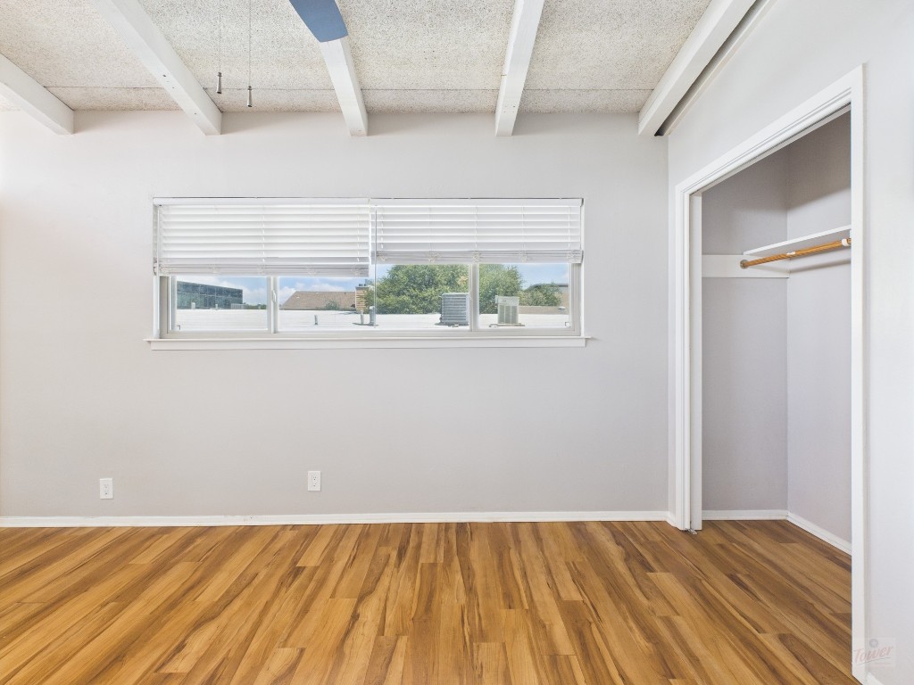2404 Longview Street, Unit 206 Austin, TX 78705 - Photo 2 of 24 an empty room with wooden floor and windows